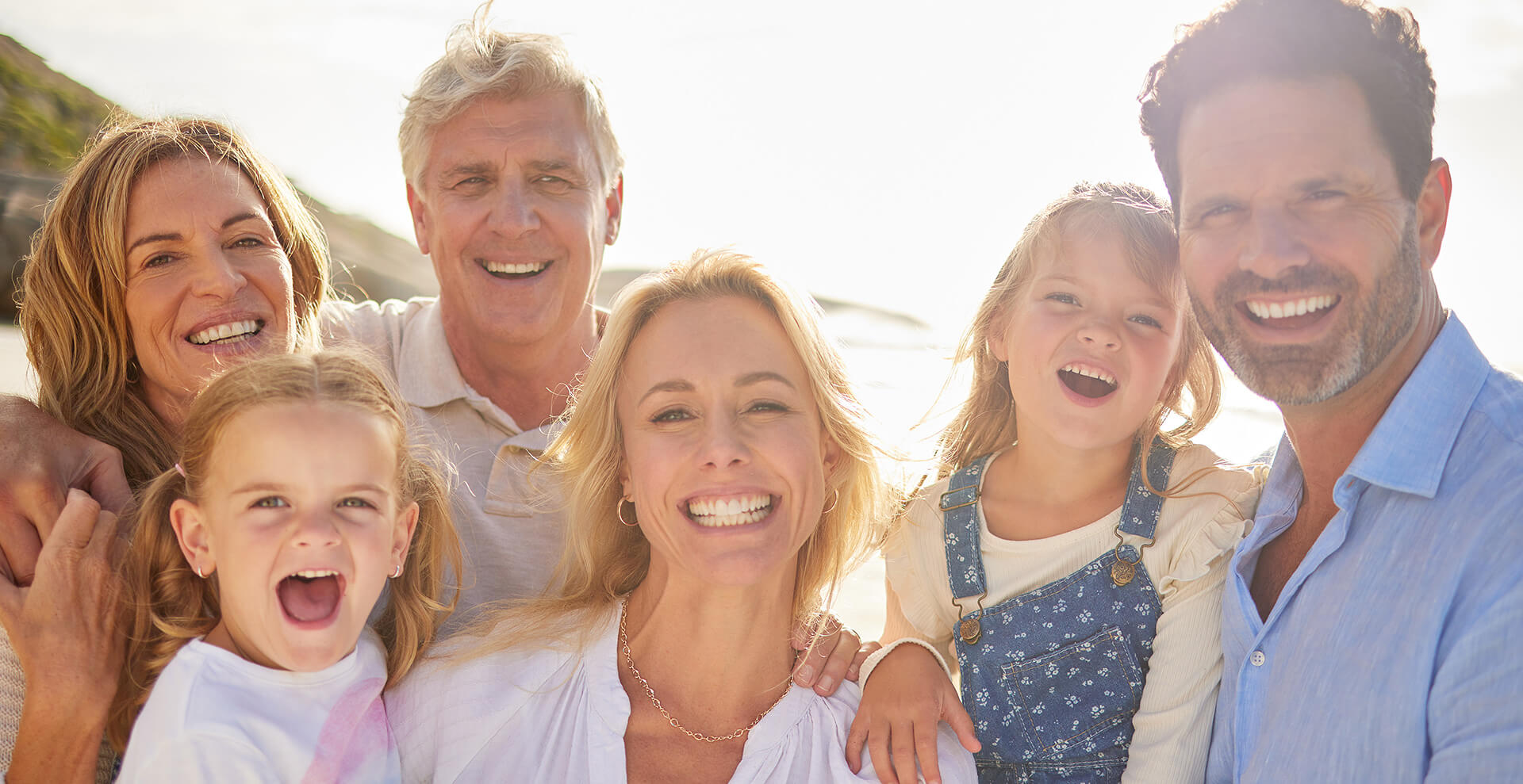 Smiling family showing healthy teeth after visiting the dentist.