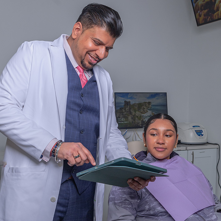 Dr. Sachin Karande providing personalized care to a patient at Karande Dental Care in a modern treatment room