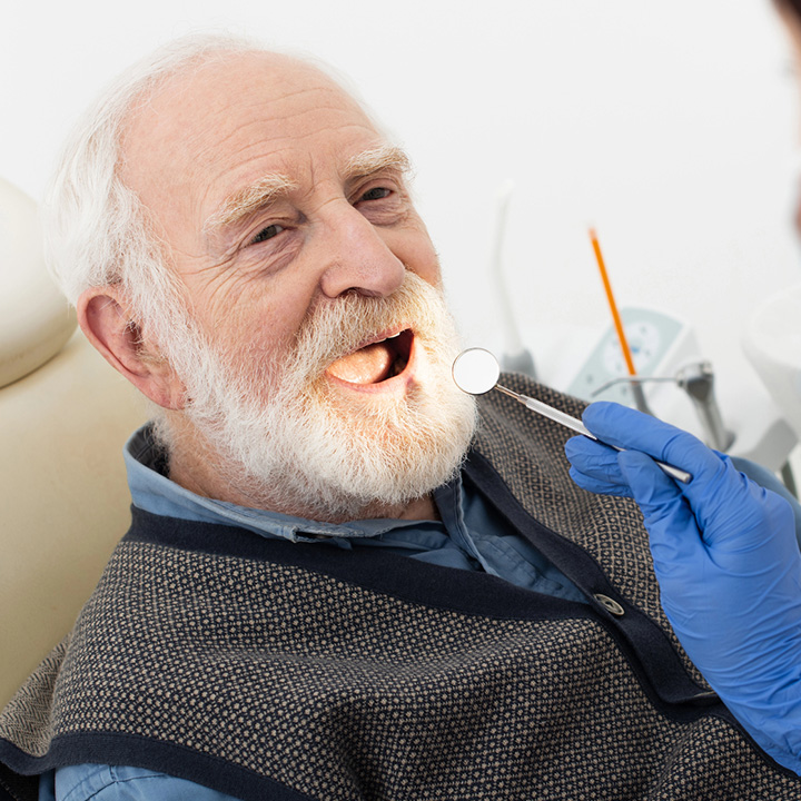 Patient receiving oral cancer screening at a clinic in Stafford, VA