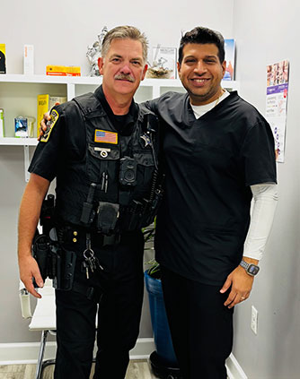 Dr. Sachin Karande with a police officer in Richmond, VA