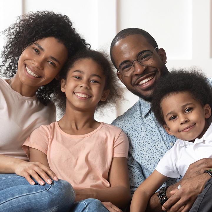 Happy father with family after receiving dental extraction in Stafford, VA