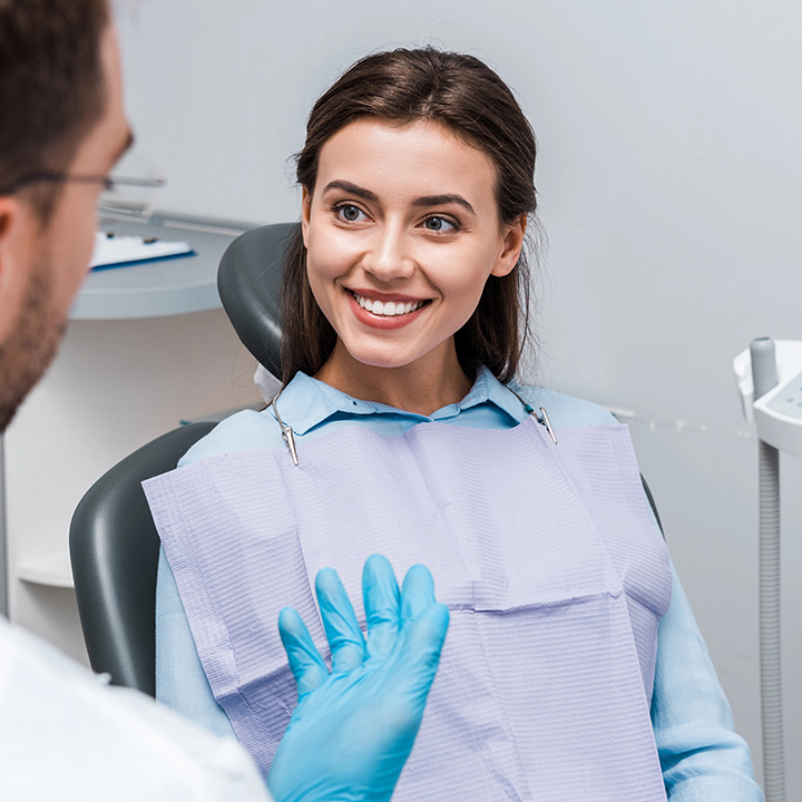 Happy woman after receiving emergency dental treatment in Stafford, VA