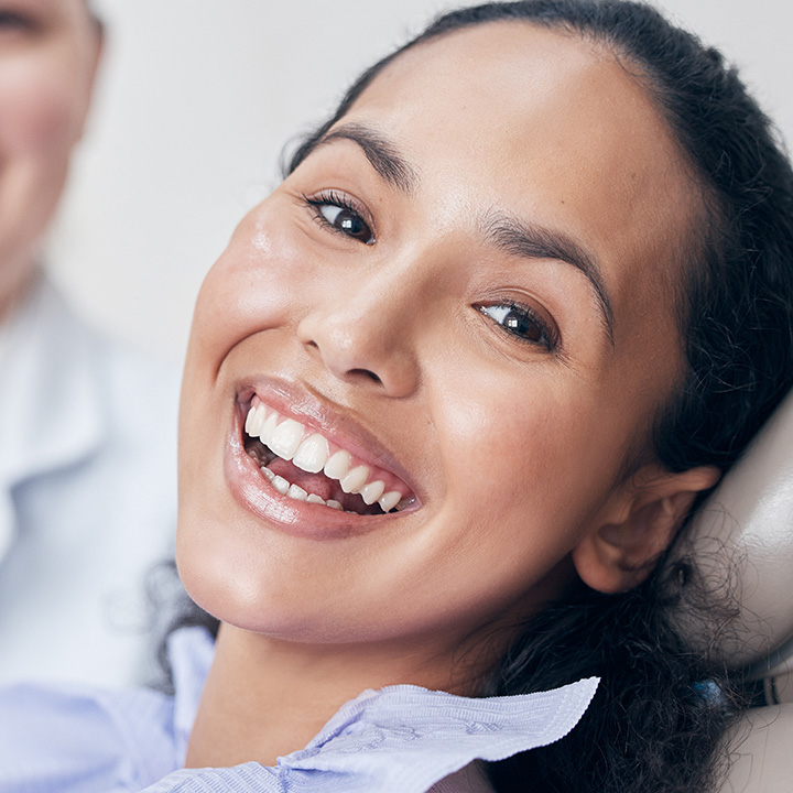Happy woman after receiving professional teeth cleaning in Stafford, VA