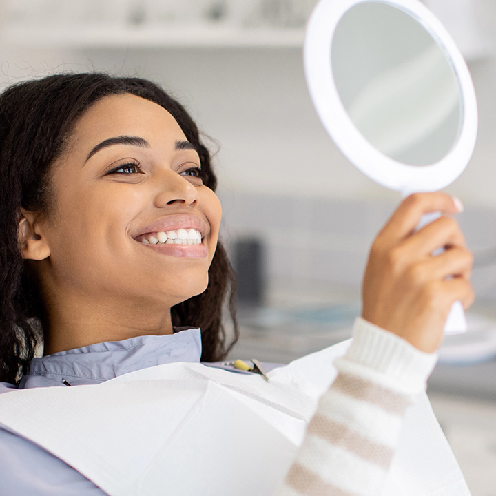 Happy woman smiling after teeth whitening treatment in Stafford, VA