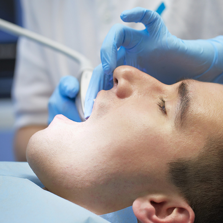 Dentist performing a dental filling procedure on a patient in Stafford, VA
