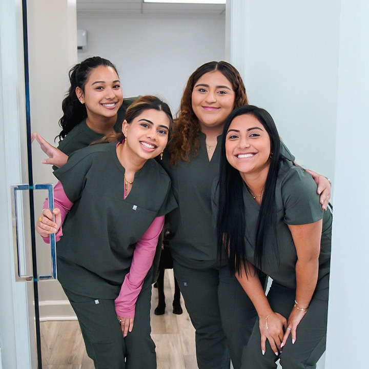 Professional dental team at Karande Dental Care smiling together in front of the clinic, ready to provide exceptional care